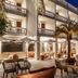 Le Mirage in Bormes-les-Mimosas features a lit outdoor terrace with tables, umbrellas and palm trees at night