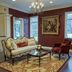 The Mount Vernon Grand Hotel in Mount Vernon lounge with chandelier, sofa, armchair, and area rug