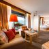 Vier Jahreszeiten Am Schluchsee suite with lake view, sofa seating, and bedroom in Schluchsee