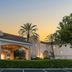 Fairfield Inn & Suites by Marriott San Francisco San Carlos exterior at sunset with palm trees and lit entrance