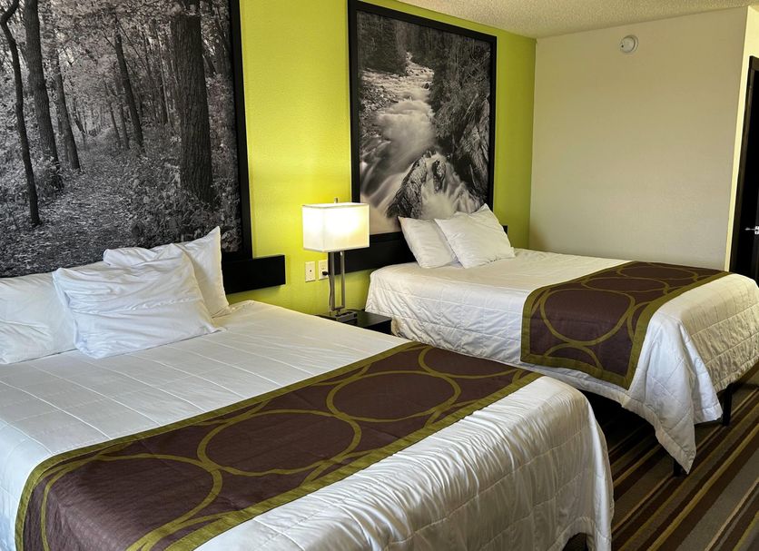 Super 8 by Wyndham Nebraska City room with two beds, lamp, and forest wall art