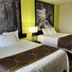 Super 8 by Wyndham Nebraska City room with two beds, lamp, and forest wall art