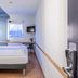 B&b Hotel Düsseldorf-Hilden room with two beds, desk, wall TV and window in Hilden