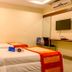 OYO 1594 Hotel Landmark room with two twin beds, wall-mounted TV, and desk in Visakhapatnam