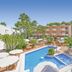 allsun Hotel Paguera Vera Beach in Peguera with outdoor pool, sun loungers and umbrellas