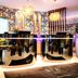 NYX Hotel Mannheim by Leonardo Hotels lobby with floral wallpaper, glossy reception desks and chandeliers
