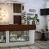 Hotel Arenas del Pacifico reception desk in La Crucecita with nautical decor and display cases