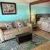 Tropical Resort & Marina on Lake Beresford in DeLand guest room with sofa, bed, and lake-themed decor