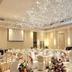 The Palace Hotel Kota Kinabalu banquet hall with round tables, white chairs, and chandeliers in Kota Kinabalu