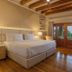 Visus Hotel Boutique & Spa in Fonda Central room with king bed, wood beam ceiling and balcony doors