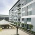 The Capital Menlyn Maine Pretoria exterior courtyard with tented seating beside modern hotel building