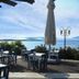 Akay Garden Family Club in Ildir: seaside terrace dining with tables, umbrellas, and sea views