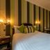 The Bedford Hotel, Tavistock guest room with striped accent wall, double bed, desk and chair