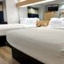 Microtel Inn & Suites by Wyndham Albertville room with two queen beds, TV and mirror