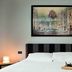 Suite Art Navona in Rome, guest room with striped headboard, framed artwork, and breakfast tray on bed