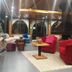Chateau D'eau Hotel in Faraya lounge with red sofas, wood tables, and arched windows