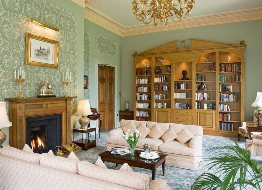 Tre-Ysgawen Hall & Spa in Llangefni: elegant lounge with fireplace, bookcase, and chandeliers