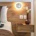 Belvedere Village in Agia Pelagia bedroom with bedside table, wall light, drinks, and fruit bowl