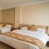 Shangmao International Hotel in Nanjing, twin-bed guest room with beige decor