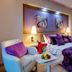 Royal Teos Thermal Resort Clinic & Spa room in Seferihisar with purple bed, armchair and bedside lamps
