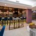 Hampton Inn New York-JFK in Queens lobby lounge with bar seating, elevator and blue sofa
