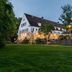 Cph Parkhotel Wolfsburg in Wolfsburg, twilight exterior with lit terrace and lawn