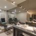 Medano Hotel and Spa Cabo San Lucas spa lounge with chairs, mirror wall and massage table