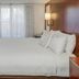 Residence Inn by Marriott Portsmouth guest room with king bed, dresser, TV and window curtains