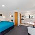 Knightsbridge Court Motor Lodge in Blenheim, studio room with king bed, kitchenette and dining table
