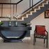 Apollo Hotel Johannesburg lobby with staircase, console table, and two accent chairs