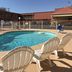 Best Budget Inn - Abilene pool area with outdoor swimming pool and lounge chairs
