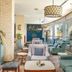 Golden Tulip Canaan Kampala lounge with cushioned seating and floor-to-ceiling windows in Kampala
