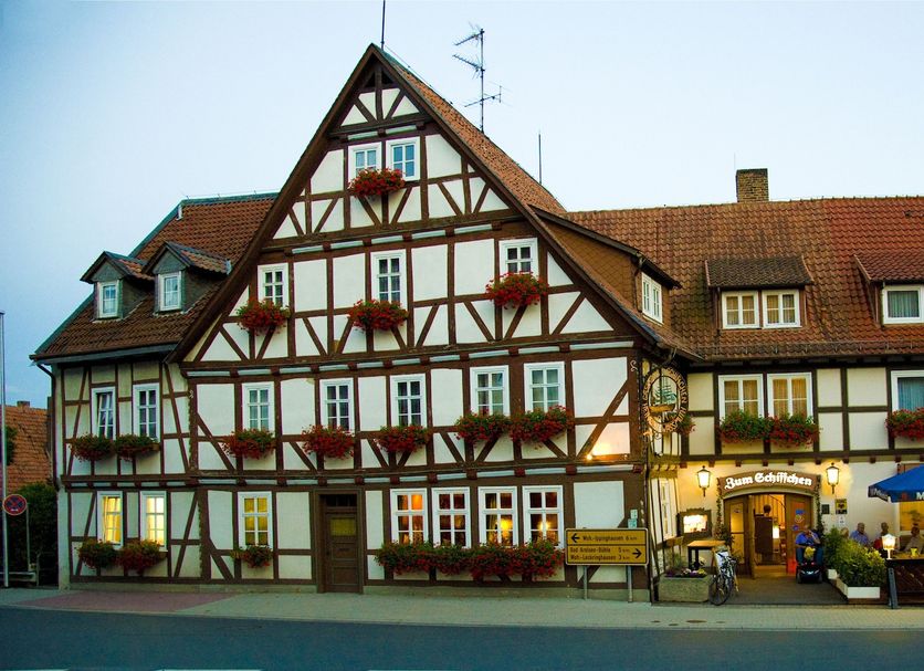 Hotel zum Schiffchen in Wolfhagen, half-timbered hotel exterior with street-side café seating
