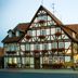 Hotel zum Schiffchen in Wolfhagen, half-timbered hotel exterior with street-side café seating