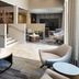 Courtyard by Marriott San Mateo Foster City lobby seating area with sofas, chairs and a TV