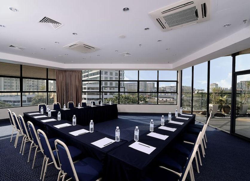 Oceania Hotel, Kota Kinabalu meeting room with U-shaped table, chairs, and city views through large windows