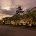 The Arnawa Hotel in Pangandaran at dusk, with palm trees and illuminated exterior