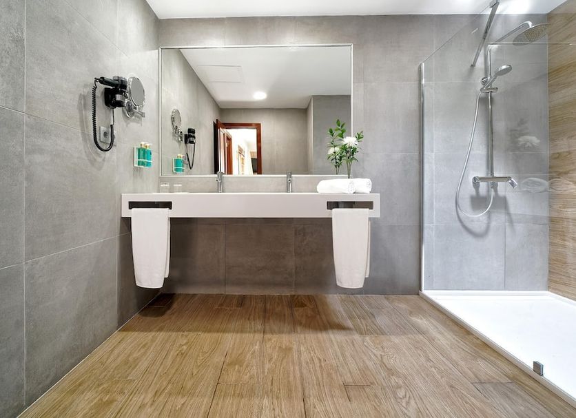 Suites & Villas by Dunas, Maspalomas: modern bathroom with walk-in shower, double sink vanity and wood floor