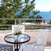 Apartments Villa Kukoljac terrace with table, white chairs and sea view in Herceg Novi