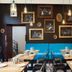 Hotel Mika Downtown Budapest dining area with blue banquette seating and framed wall art