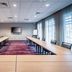 Courtyard by Marriott Toledo West meeting room with U-shaped tables, projector screen and large windows in Toledo