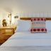 Palace Hill Hotel in Scarborough bedroom with a neatly made bed, bedside tables and wall lamps