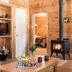 Sterling Ridge Resort in Jeffersonville cabin with wood stove, living room seating, and bedroom doorway