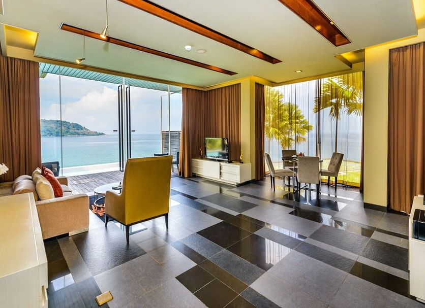 Impiana Private Villas Kata Noi in Karon with ocean-view living area, sliding glass doors, and dining table