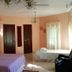Mansion Giahn Bed & Breakfast room in Cancún with bed, tiled floor, windows and ceiling fan