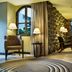 Movich Casa del Alferez in Cali: stylish lounge with arched window, lamps, chairs and bar seating