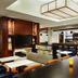 Hyatt House Denver Airport lounge with bar seating, booths, and a mounted TV in Denver