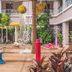 Starlodge in Jerudong: tropical courtyard pool with palm trees, water feature, and lounge area