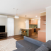 Statesman Hotel Canberra living room with TV, sofa, dining nook and kitchen area