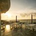 Viewtower Resort in Jeju City rooftop terrace with tables and ocean sunset view